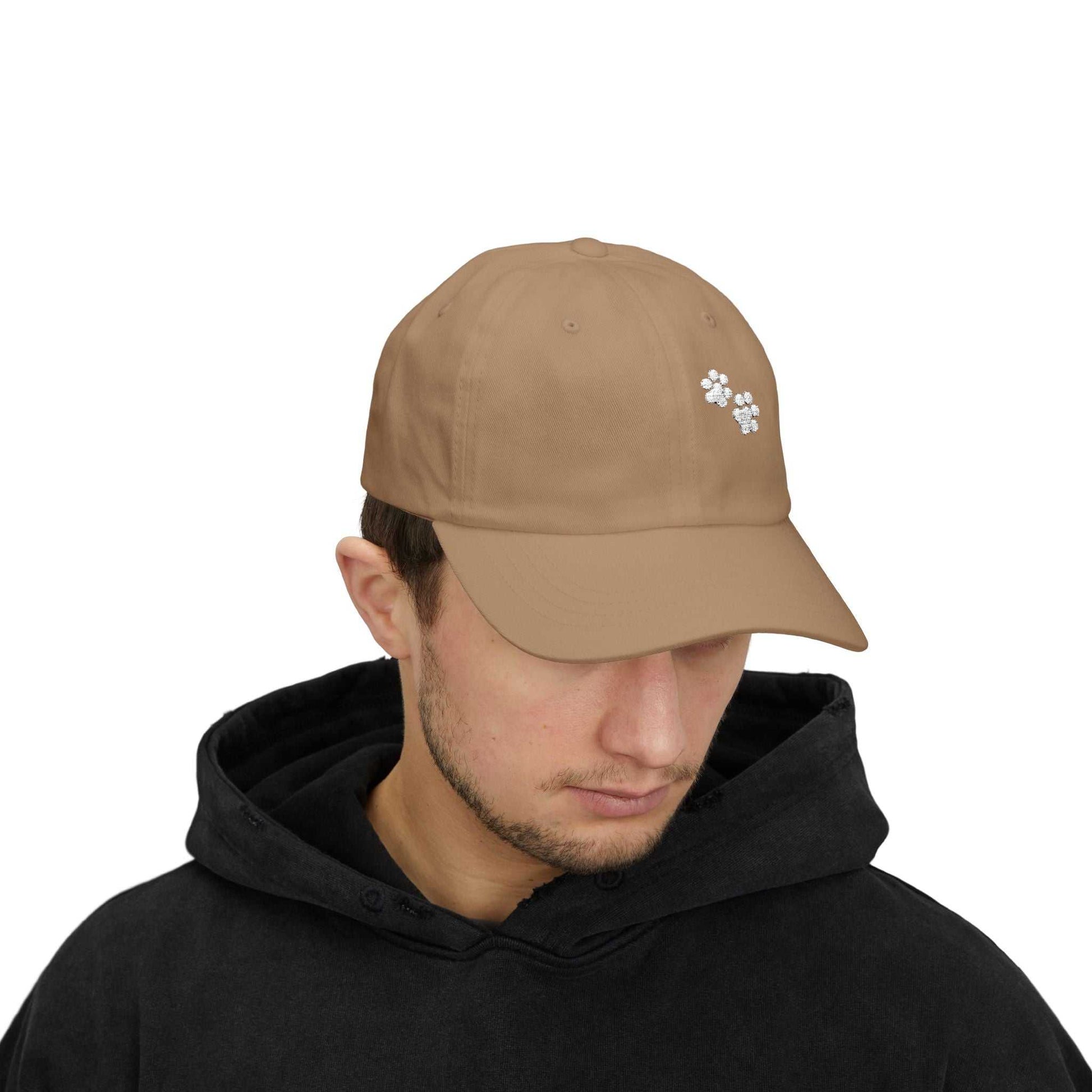 Classic dad cap with paw print, relaxed fit, adjustable snap closure, ideal for pet lovers.