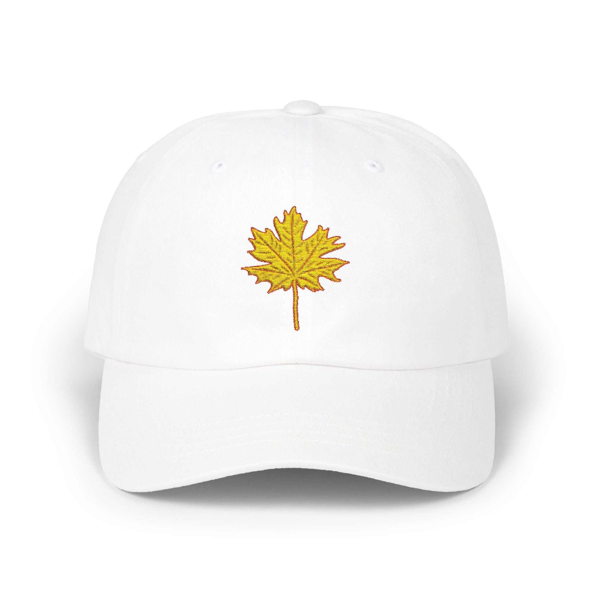 White Dad Cap with embroidered yellow maple leaf design, casual unstructured fit.