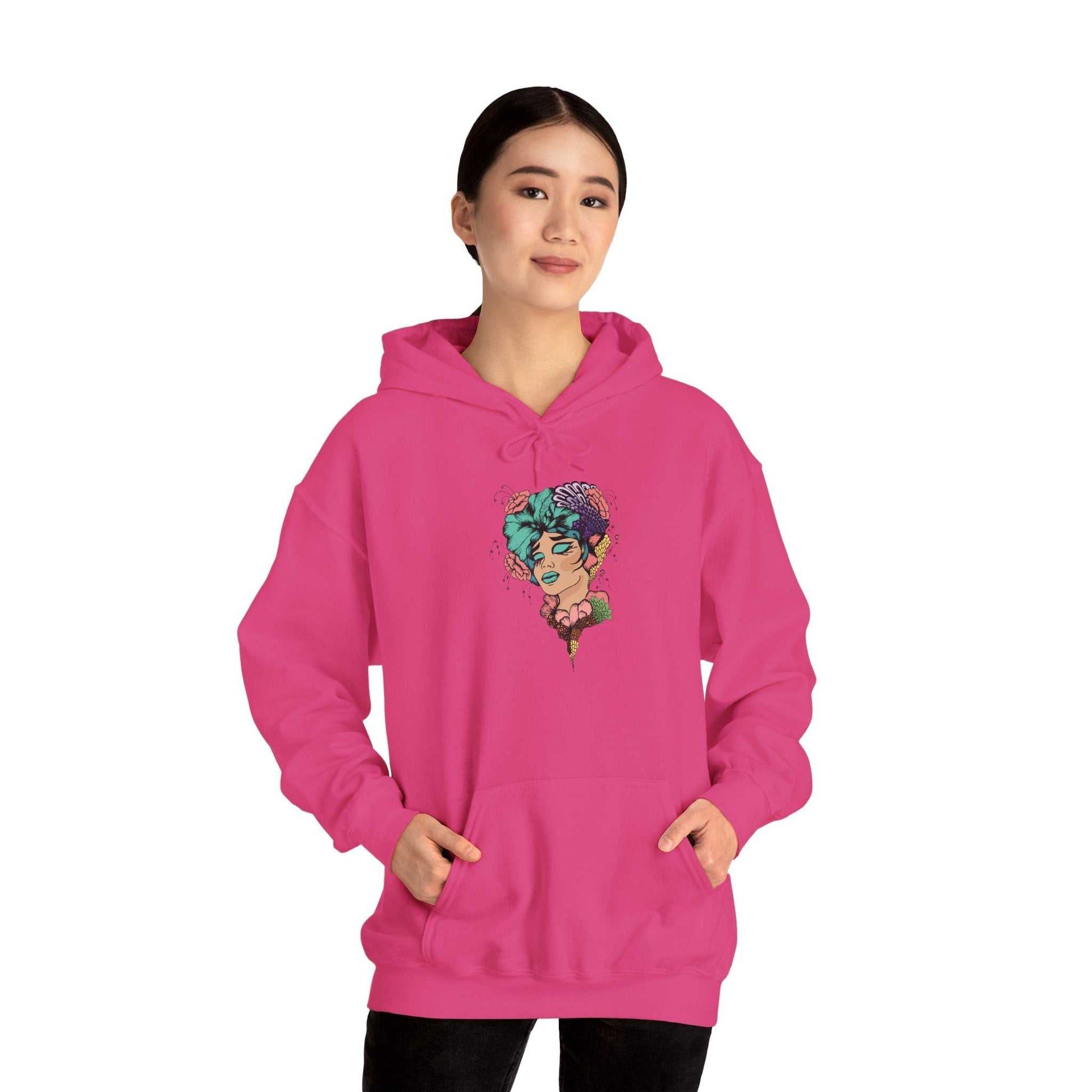 Boho style hooded sweatshirt in pink with a vibrant design, modeled by a person.
