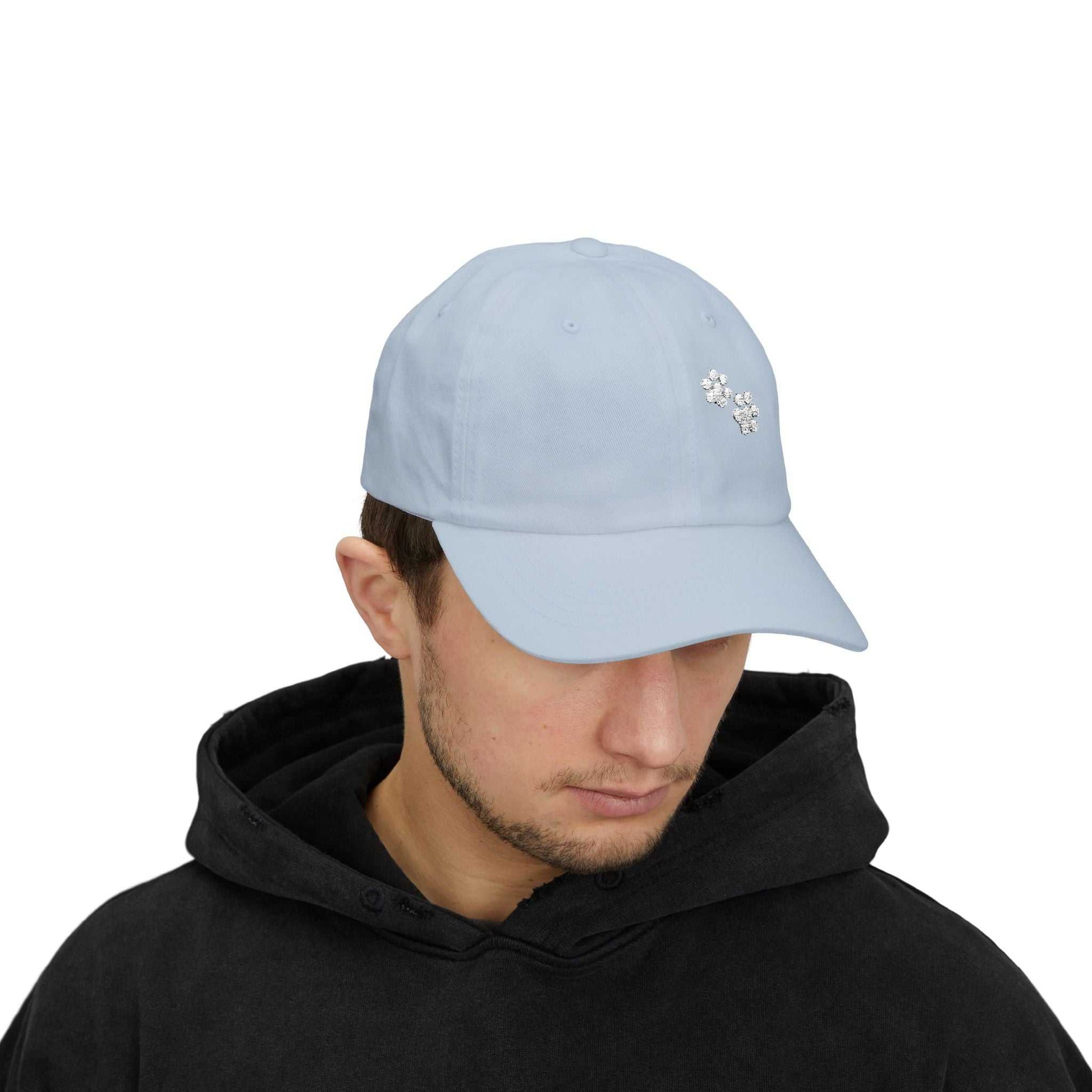Classic blue dad cap with embroidered paw print, ideal for casual and outdoor use.